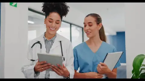 Healthcare professionals reviewing a tablet together