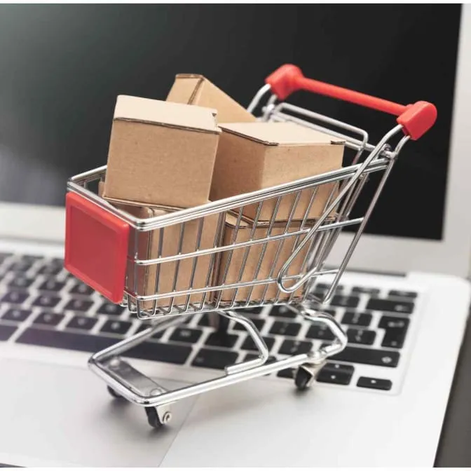Shopping cart beside an online storefront